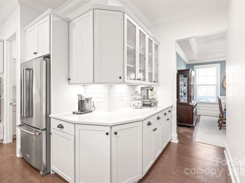 128 Shimmer Lake Lane, Belmont, NC 28012.  MLS# CAR4208573, YatesRealty ID 9390. A thoughtful design! Additional cabinets leading into the formal dining room are perfect for a coffee station or bar area—ideal for entertaining.