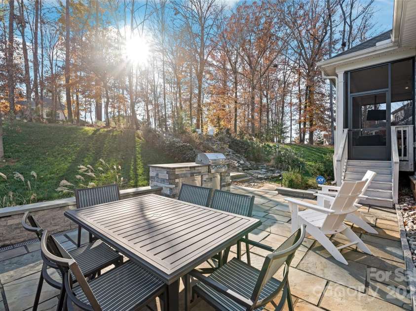 128 Shimmer Lake Lane, Belmont, NC 28012.  MLS# CAR4208573, YatesRealty ID 9390. Elevate your outdoor living! The custom stone paver patio and built-in outdoor grill create the perfect setting for entertaining and enjoying meals alfresco.