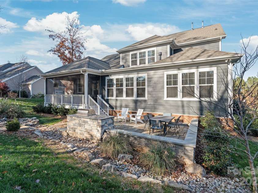 128 Shimmer Lake Lane, Belmont, NC 28012.  MLS# CAR4208573, YatesRealty ID 9390. Enjoy the perfect blend of comfort and beauty with custom screened-in porch and stone paver patio—ideal for relaxing, dining, and soaking in the serene outdoors.