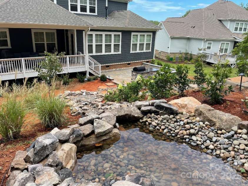 128 Shimmer Lake Lane, Belmont, NC 28012.  MLS# CAR4208573, YatesRealty ID 9390. Photo of pond and waterfall with water. Currently turned off for the winter.