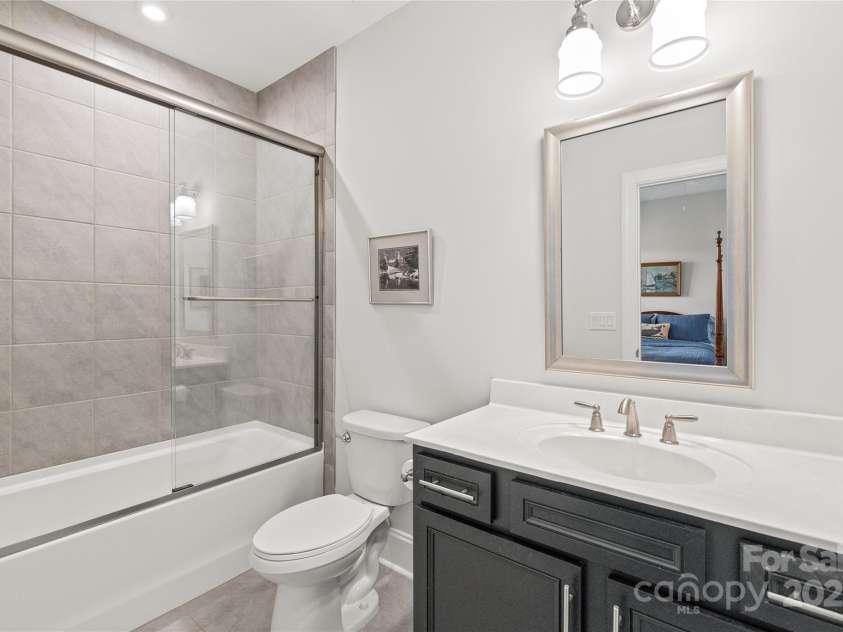 128 Shimmer Lake Lane, Belmont, NC 28012.  MLS# CAR4208573, YatesRealty ID 9390. The full bathroom for Bedroom 2 offers a private oasis with elegant finishes and thoughtful design.