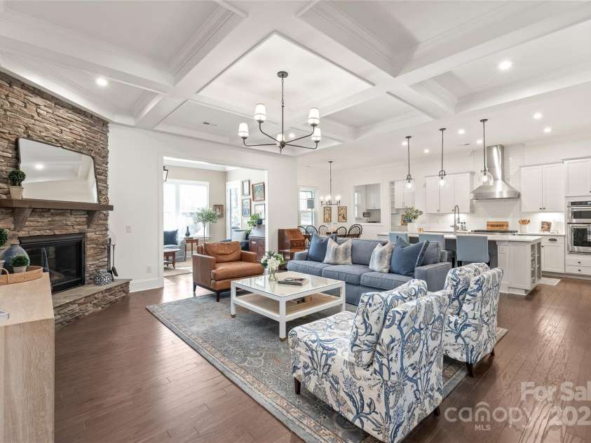128 Shimmer Lake Lane, Belmont, NC 28012.  MLS# CAR4208573, YatesRealty ID 9390. The heart of the home! This open-concept great room with coffered ceilings flows seamlessly into the gourmet chef's kitchen, sunroom, & pocket office—perfect for living, entertaining, & everything in between.