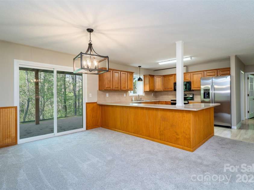 145 Jeter Mountain Road, Hendersonville, NC 28739.  MLS# CAR4281389, YatesRealty ID 94. Sliding door looking out to the woods