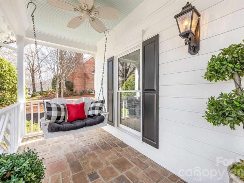 6203 Kensington Gardens Court, Charlotte, NC 28277.  MLS# CAR4343477, YatesRealty ID 9426. Dual ceiling fans and a porch swing are 