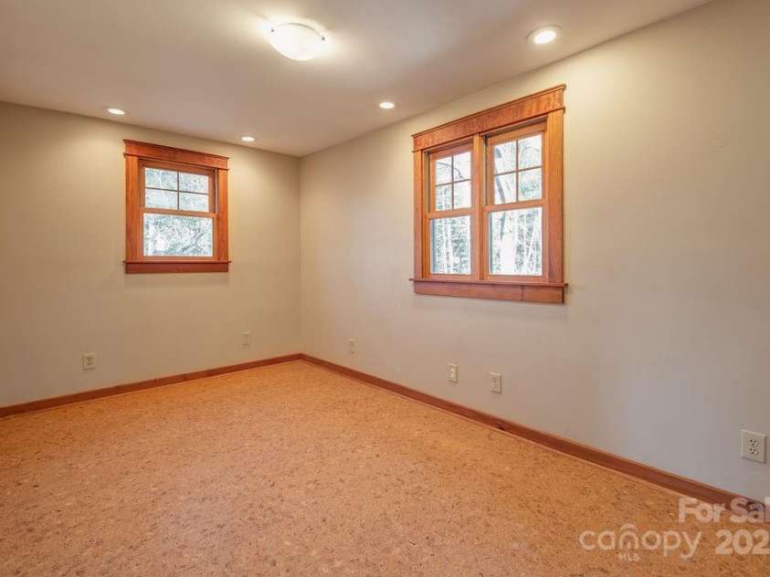 14 Woods Drive, Fairview, NC 28730.  MLS# CAR4223729, YatesRealty ID 9429. Bedroom 2 with beautiful wood trim.