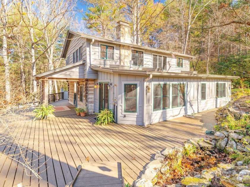 14 Woods Drive, Fairview, NC 28730.  MLS# CAR4223729, YatesRealty ID 9429. Front and side of house with a wraparound deck.