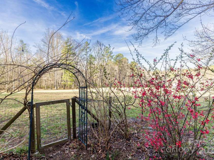 14 Woods Drive, Fairview, NC 28730.  MLS# CAR4223729, YatesRealty ID 9429. Gate to the pasture. The yard around the house is fenced for your pet.