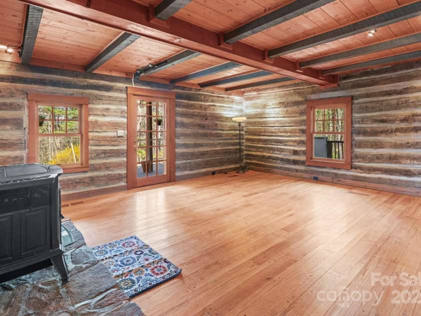 14 Woods Drive, Fairview, NC 28730.  MLS# CAR4223729, YatesRealty ID 9429. Living room with wormy chestnut logs.