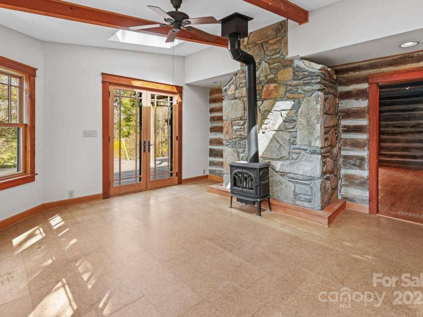 14 Woods Drive, Fairview, NC 28730.  MLS# CAR4223729, YatesRealty ID 9429. Sunroom with wood burning stove.