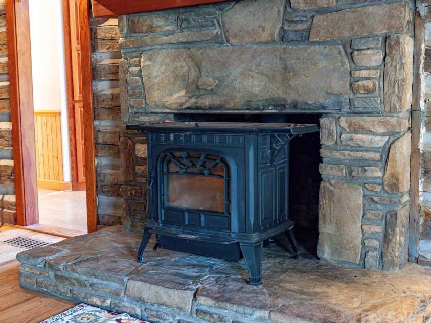 14 Woods Drive, Fairview, NC 28730.  MLS# CAR4223729, YatesRealty ID 9429. Wood stove in the living room.