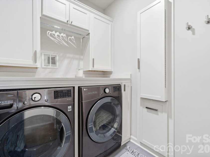 30132 Turtle Point Court, Lancaster, SC 29720.  MLS# CAR4360066, YatesRealty ID 9433. Laundry room with custom storage, counter and pull down ironing board
