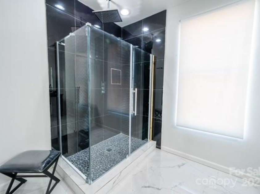 174 Crooked Creek Estates, Old Fort, NC 28762.  MLS# CAR4247439, YatesRealty ID 9447. A secondary bathroom that is extraordinary with luxurious flooring and spa-like rainshower.