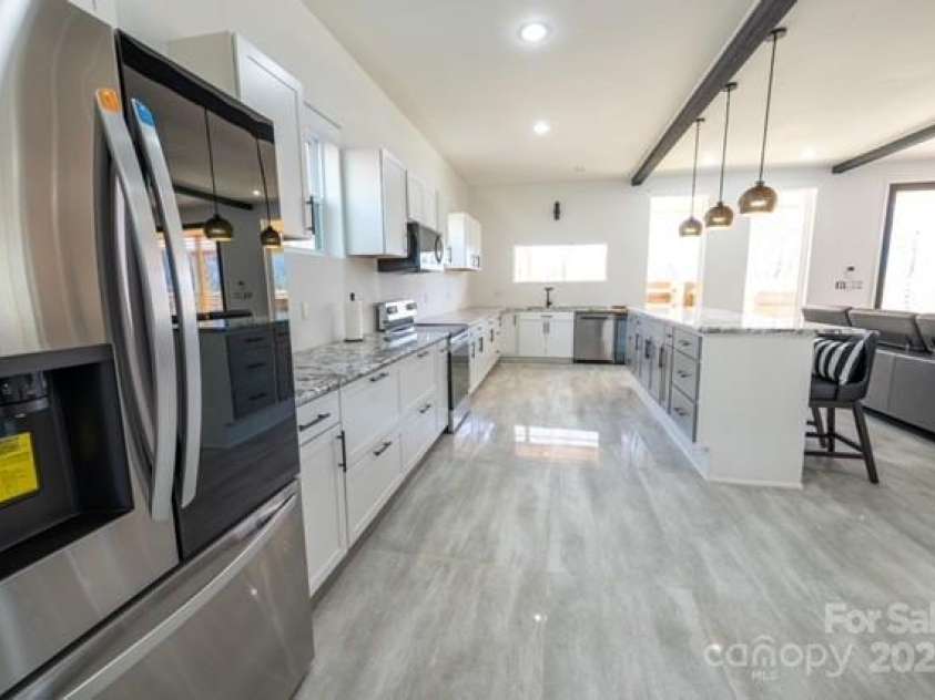 174 Crooked Creek Estates, Old Fort, NC 28762.  MLS# CAR4247439, YatesRealty ID 9447. Another look at the kitchen off the living area. Plenty of room to enjoy gourmet or simple meals.