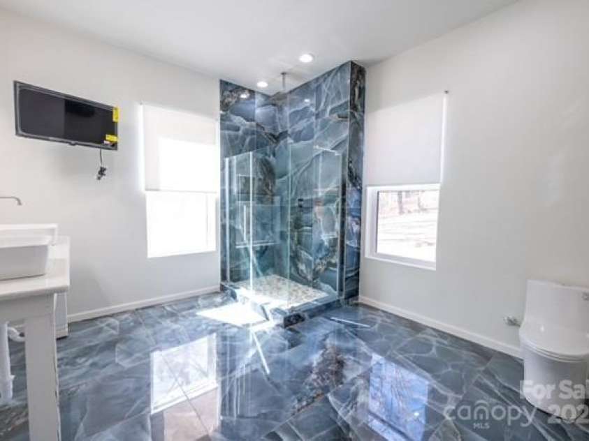 174 Crooked Creek Estates, Old Fort, NC 28762.  MLS# CAR4247439, YatesRealty ID 9447. Gorgeous primary bathroom features porcelain tile and a rainshower spa experience.