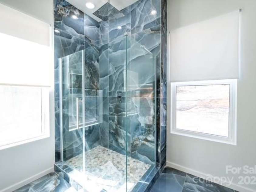 174 Crooked Creek Estates, Old Fort, NC 28762.  MLS# CAR4247439, YatesRealty ID 9447. The spa-like rainshower offers an exhilirating luxe cleansing experience.