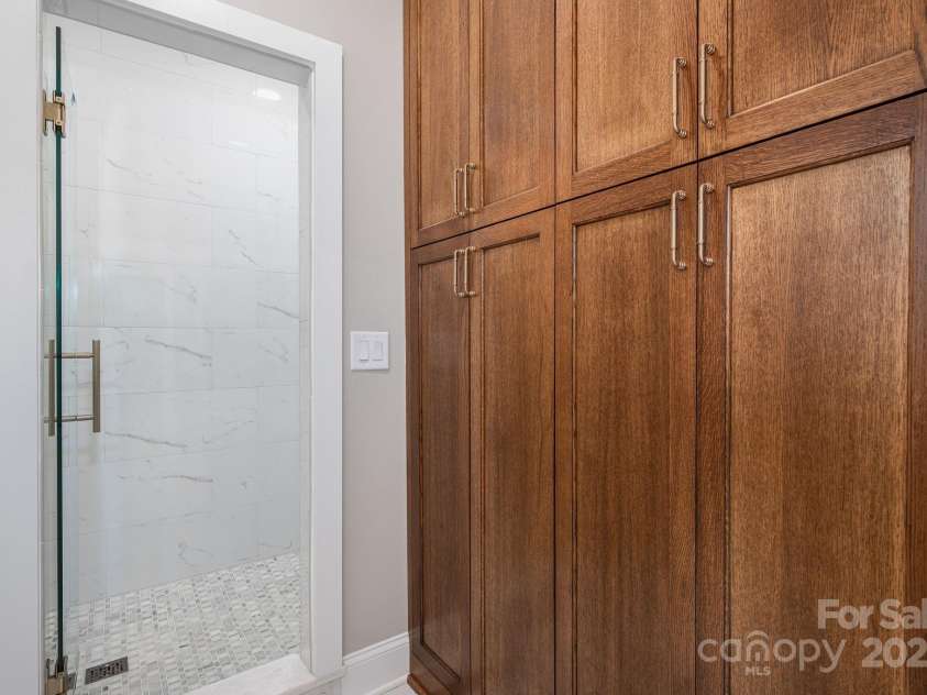 7701 Gold Hill Road, Rockwell, NC 28138.  MLS# CAR4246769, YatesRealty ID 9456. Beautiful cabinetry leading to extra large enclosed primary shower.