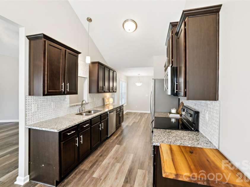 104 Candace Court, Stanley, NC 28164.  MLS# CAR4353115, YatesRealty ID 9471. Kitchen with Granite Counters and Stainless Applianes