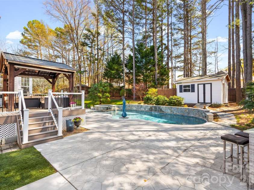 12141 Stone Forest Drive, Pineville, NC 28134.  MLS# CAR4360442, YatesRealty ID 9475. Beautiful pool/spa 