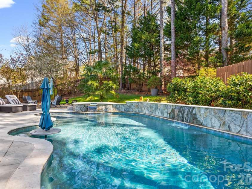 12141 Stone Forest Drive, Pineville, NC 28134.  MLS# CAR4360442, YatesRealty ID 9475. Pool with tanning ledge and built in table and bench seating 