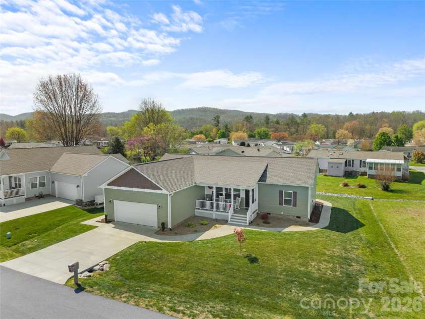 432 Sassafras Drive, Hendersonville, NC 28739.  MLS# CAR4366185, YatesRealty ID 9484. Aerial View – Elevated perspective showcasing the home’s setting with surrounding rooftops and scenic mountain backdrop, highlighting the peaceful community feel.