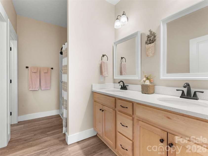432 Sassafras Drive, Hendersonville, NC 28739.  MLS# CAR4366185, YatesRealty ID 9484. Primary Bathroom – Double vanity with ample counter space and storage, complemented by bright lighting and a clean, modern feel.