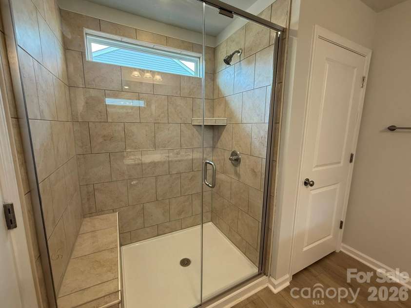 1231 Bansal Drive, Charlotte, NC 28215.  MLS# CAR4363373, YatesRealty ID 9491. Tile Shower in Primary Bathroom