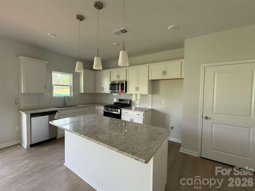 1305 Bansal Drive, Charlotte, NC 28215.  MLS# CAR4360795, YatesRealty ID 9492. The Kitchen features white cabinets and granite countertops