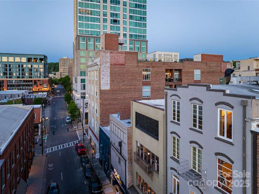 35 Patton Avenue, Asheville, NC 28801.  MLS# CAR4299187, YatesRealty ID 9493. 35 Patton # 402 is top floor /far right vertical windows with lights on inside. This oasis is in the heart of downtown Asheville.