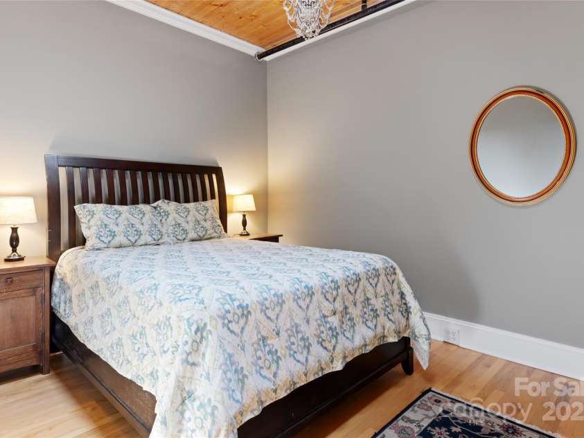 35 Patton Avenue, Asheville, NC 28801.  MLS# CAR4299187, YatesRealty ID 9493. Cozy and tranquil primary bedroom offers a nice oasis from exploring the streets of downtown Asheville