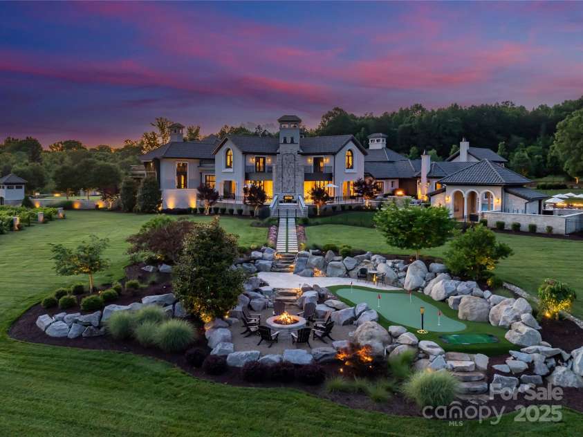 18308 Shearer Road, Davidson, NC 28036.  MLS# CAR4289423, YatesRealty ID 95. Side Elevation featuring private putting green and fire pit.