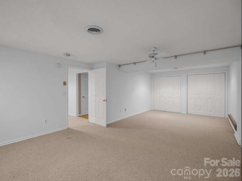 335 Melrose Avenue, Tryon, NC 28782.  MLS# CAR4417394, YatesRealty ID 9529. Lower level bedroom