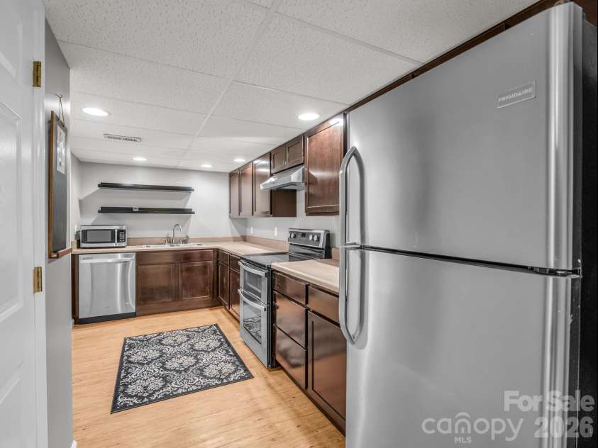 335 Melrose Avenue, Tryon, NC 28782.  MLS# CAR4417394, YatesRealty ID 9529. Lower level kitchen with stainless appliances