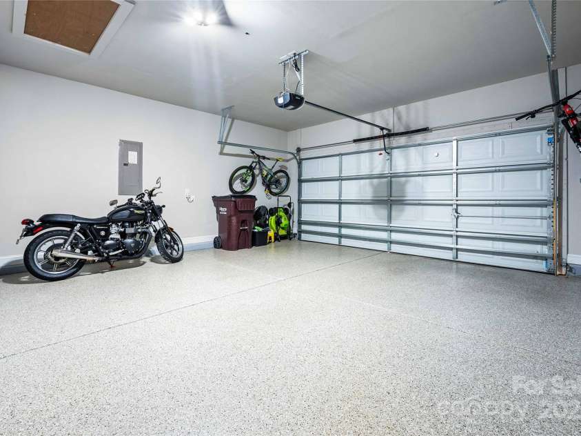 2914 Hiddenbrook Way, Indian Land, SC 29707.  MLS# CAR4227990, YatesRealty ID 9536. Epoxy flooring in finished garage with updated lighting