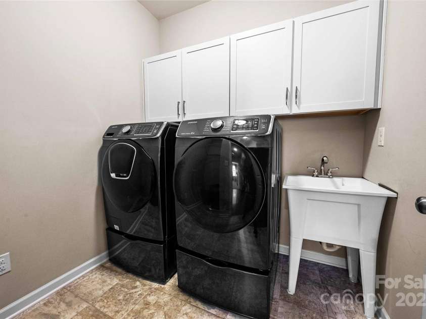 2914 Hiddenbrook Way, Indian Land, SC 29707.  MLS# CAR4227990, YatesRealty ID 9536. Spacious laundry room with utility sink and storage cabinetry