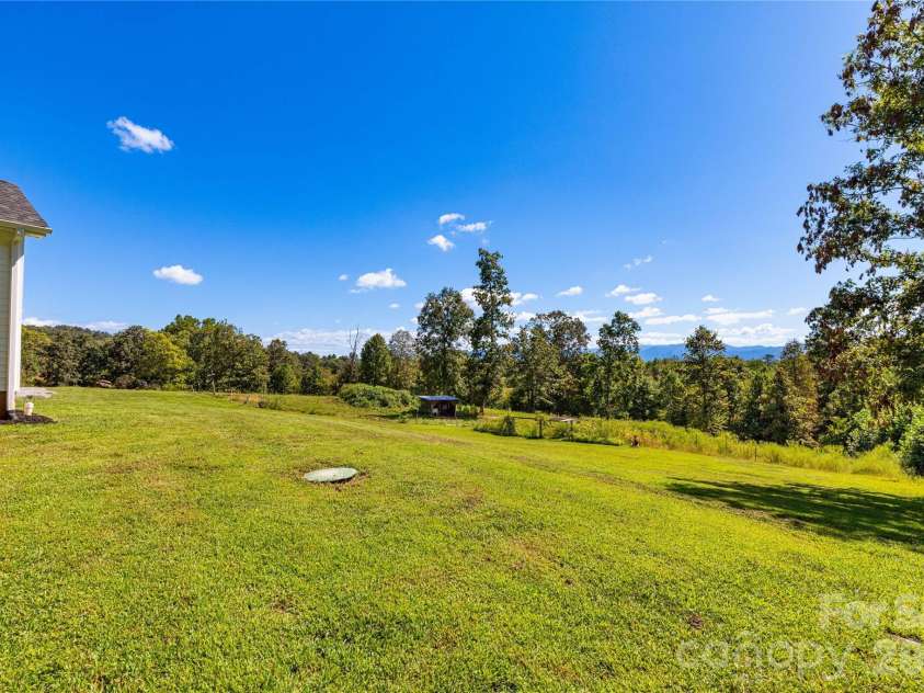 653 Mag Sluder Road, Alexander, NC 28701.  MLS# CAR4299475, YatesRealty ID 9536. Side Yard 