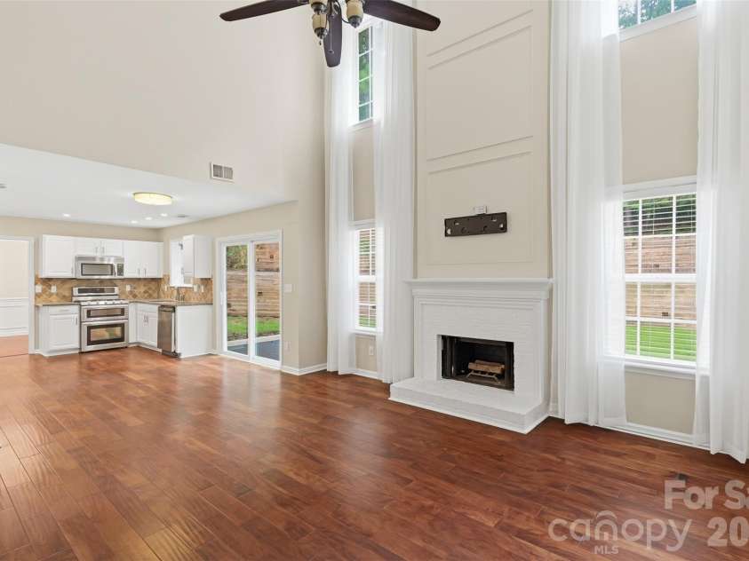 14339 Crown Harbor Drive, Charlotte, NC 28278.  MLS# CAR4415529, YatesRealty ID 9547. Living Room with Fireplace opens to the kitchen.