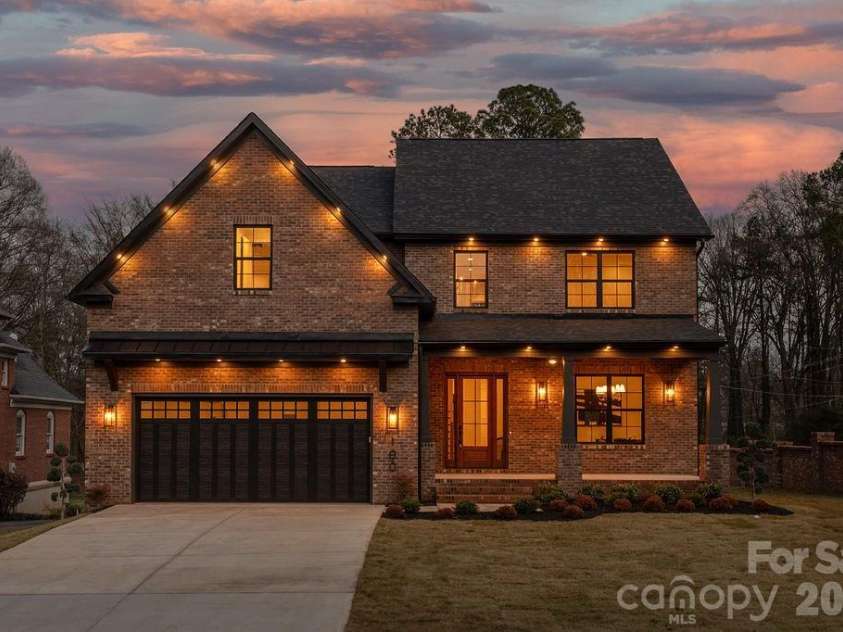 100 Brackenbury Lane, Charlotte, NC 28270.  MLS# CAR4352384, YatesRealty ID 9578. Front twilight.