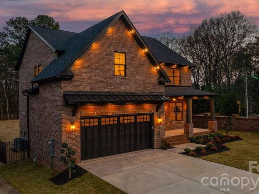 100 Brackenbury Lane, Charlotte, NC 28270.  MLS# CAR4352384, YatesRealty ID 9578. Side twilight.