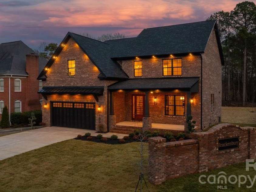 100 Brackenbury Lane, Charlotte, NC 28270.  MLS# CAR4352384, YatesRealty ID 9578. Side twilight.