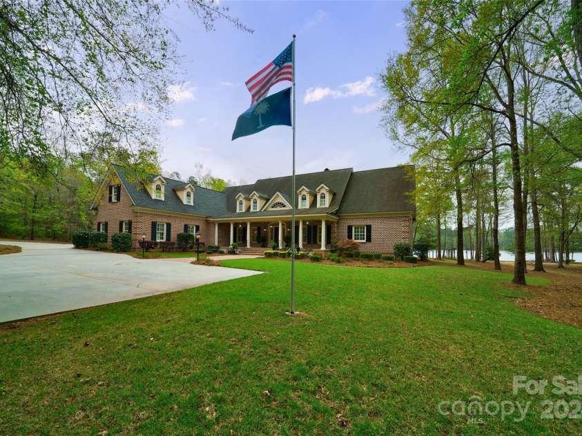 229 Joseph Kershaw Road, Eastover, SC 29044.  MLS# CAR4122309, YatesRealty ID 958. 8,400 sq ft Primary Charleston inspired home overlooking the lake offers 4 bedrooms, 5 full and 2 half bathrooms