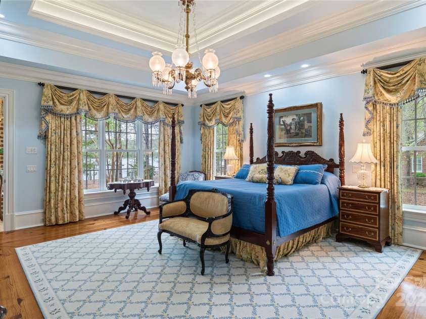 229 Joseph Kershaw Road, Eastover, SC 29044.  MLS# CAR4122309, YatesRealty ID 958. Primary Bedroom overlooking the lake with access to the sunroom, 3 tiered tray ceiling w/lighting