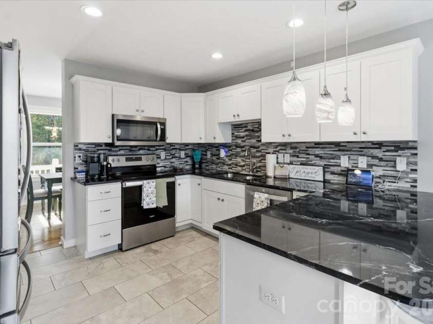 9 Old Amber Drive, Weaverville, NC 28787.  MLS# CAR4320794, YatesRealty ID 9583. Kitchen view to Dining Area