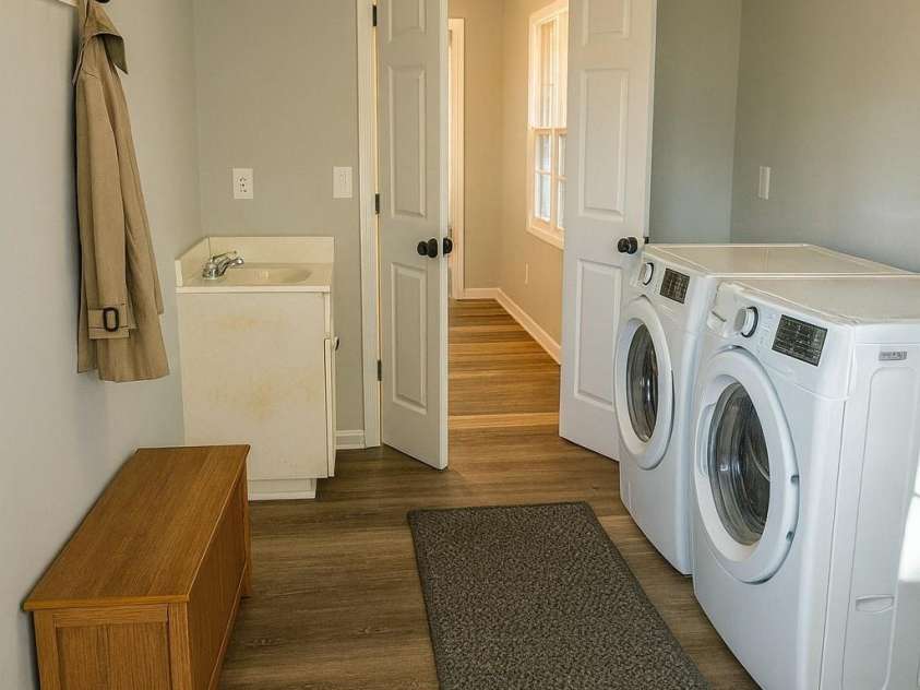 44585 Baldwin Road, New London, NC 28127.  MLS# CAR4323021, YatesRealty ID 9591. Virtually staged mud room with utility sink and door accessing back deck/yard