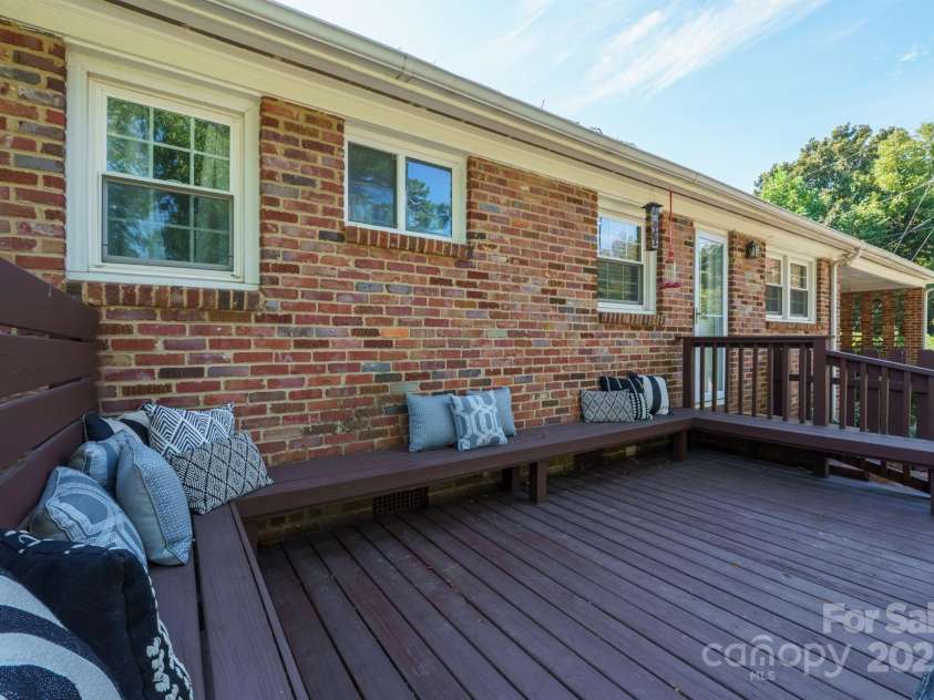 5748 Farmbrook Drive, Charlotte, NC 28210.  MLS# CAR4302947, YatesRealty ID 9592. Oversized Deck with wrap around bench seating!