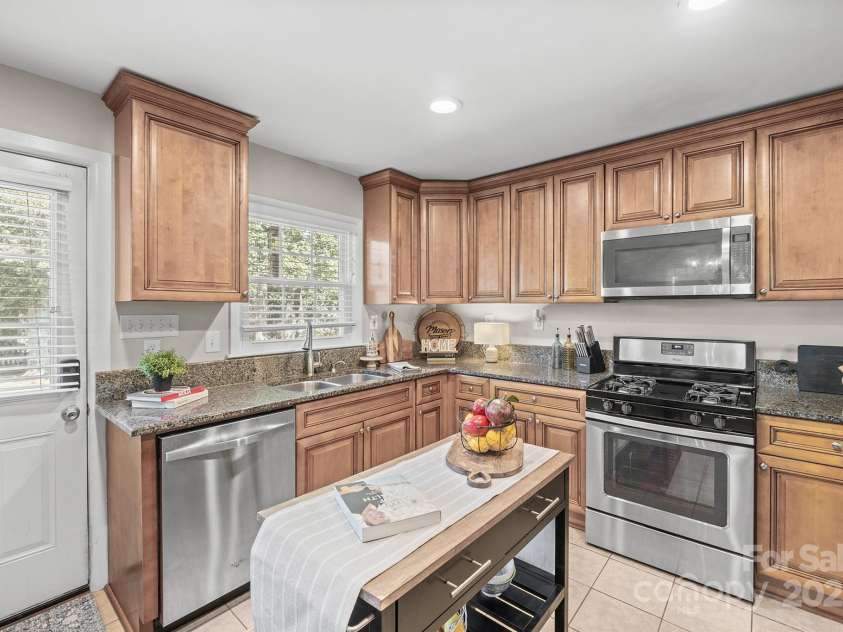 5748 Farmbrook Drive, Charlotte, NC 28210.  MLS# CAR4302947, YatesRealty ID 9592. Upgraded Kitchen offers granite counters, stainless steel appliances including Refrigerator to remain, gas range & plenty of cabinetry for storage!