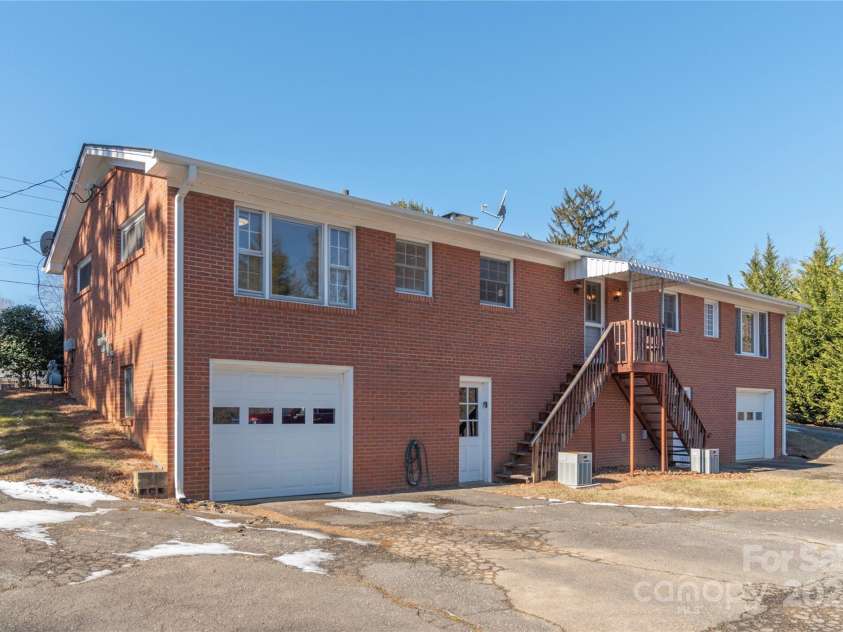 114/116 Arco Road, Asheville, NC 28805.  MLS# CAR4227410, YatesRealty ID 9606. Garage in back of right side of duplex