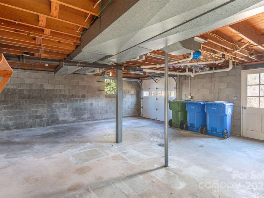 114/116 Arco Road, Asheville, NC 28805.  MLS# CAR4227410, YatesRealty ID 9606. Left side- basement garage and plenty of storage