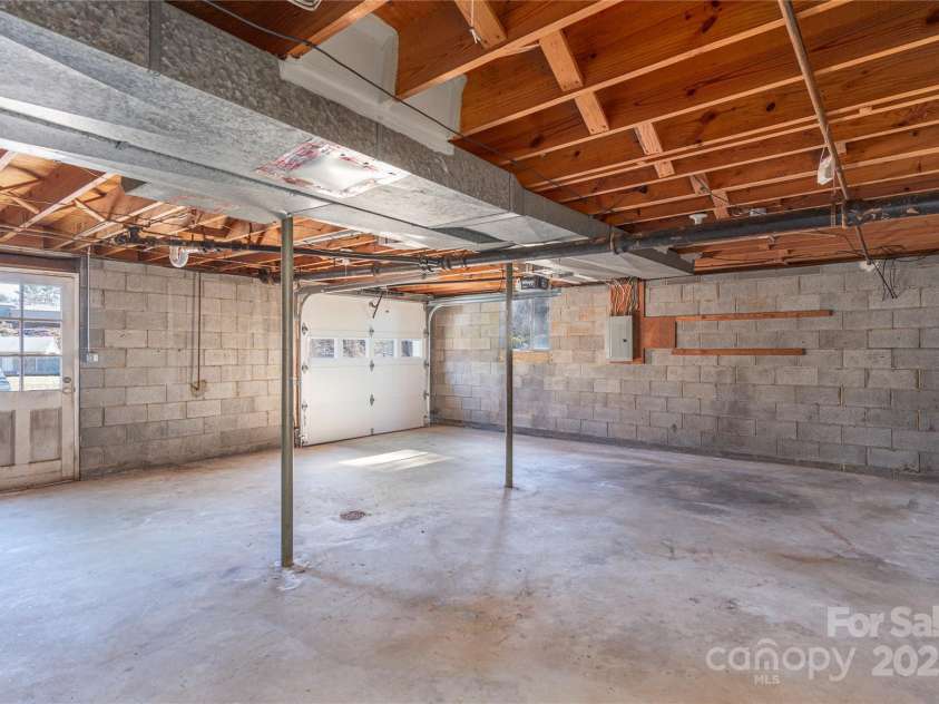 114/116 Arco Road, Asheville, NC 28805.  MLS# CAR4227410, YatesRealty ID 9606. Right side- Garage basement with lots of storage