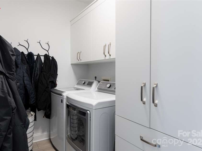 15 Dayflower Drive, Asheville, NC 28803.  MLS# CAR4209774, YatesRealty ID 9613. Main level laundry room with LG washer and dryer and custom cabinets