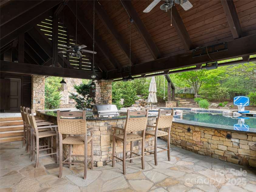 32 Ramble Way, Asheville, NC 28803.  MLS# CAR4251948, YatesRealty ID 9614. Outdoor Kitchen and pool with swim-up bar